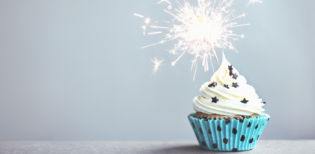 Blue cupcake with sparkler candle in it.