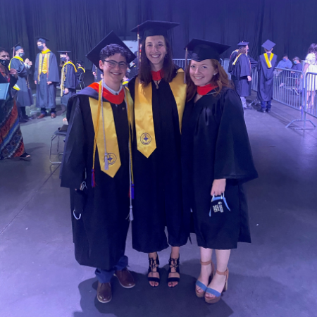Izy Engel, Hayley Tovey, and Regan Tarasewicz posing during their college graduation wearing caps and gowns