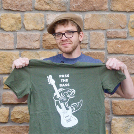 Dylan Flynn poses with a Pass The Bass t-shirt