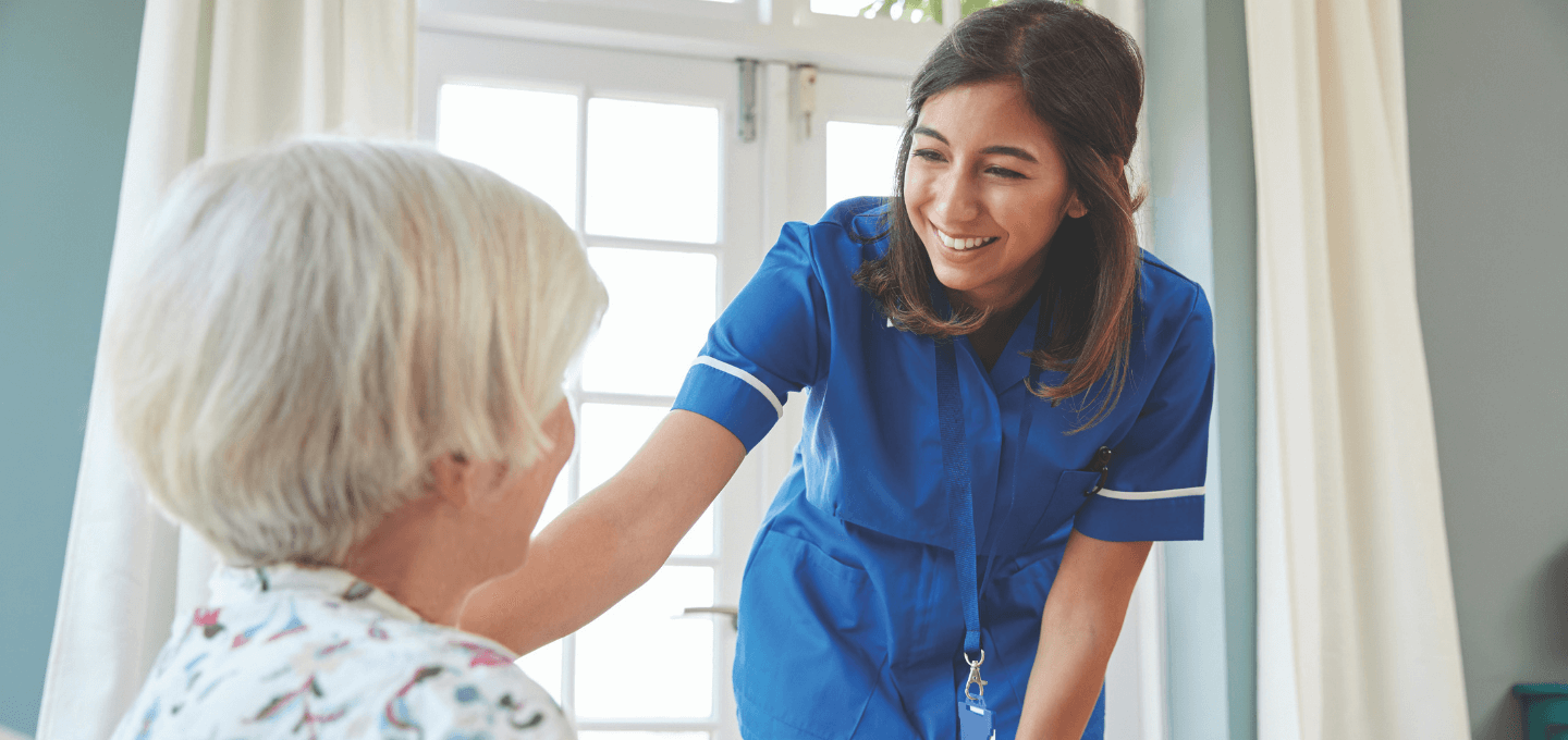 Nurse smiling at female patient
