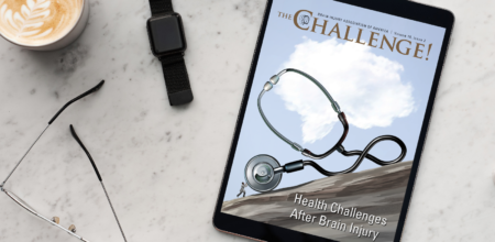 The Challenge Vol. 15 Iss. 2 on Health Challenges displayed on iPad laying on marble table next to cappuccino and glasses.